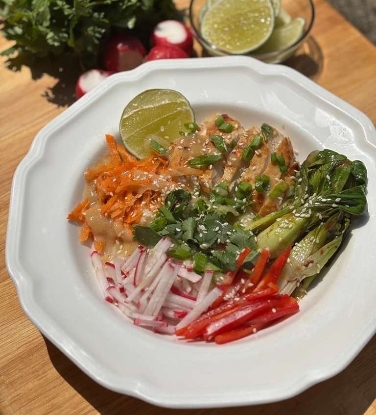A bowl of miso noodles with crisp vegetables and a ginger miso dressing.